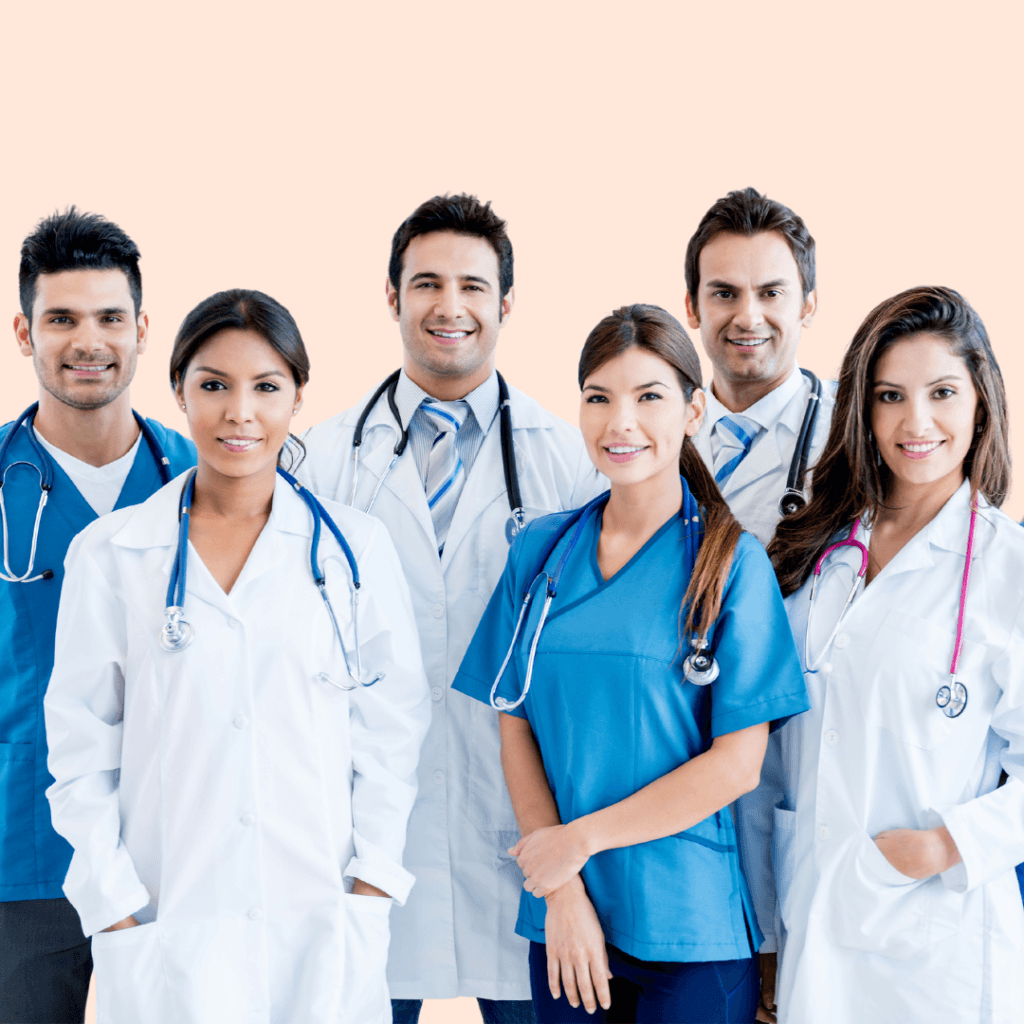 Un grupo de seis profesionales médicos con batas quirúrgicas y batas de laboratorio, sonrientes y alineados sobre un fondo claro, encarnan a la perfección el espíritu de nuestra filosofía "Quiénes somos".