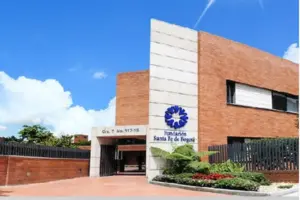 Exterior view of the Fundación Santa Fe de Bogotá building with a blue sky and some clouds in the background, a notable landmark in Latin America known for its advanced medical services, including competitive Full Body MRI Cost options.