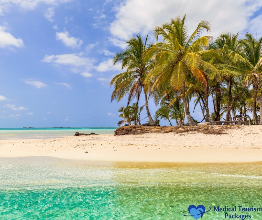 Tropical beach with clear turquoise water, white sand, and palm trees under a partly cloudy sky—showcasing Panama tourism. "Medical Tourism Packages" logo in lower right corner.